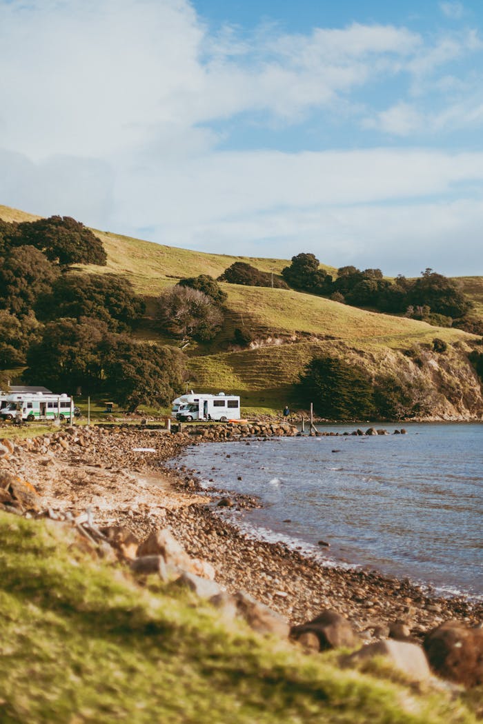 Mastering the First Impression: Your intriguing post title goes here Explore the serene coastline of Coromandel with RVs parked by the sea.